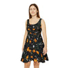 Halloween pattern featuring cute crows, skulls, bats, pumpkins, a few spiders, and some creepy tree branches, on a dress, black background