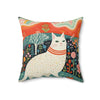 White cat pillow in a field of flowers, teal, orange, white